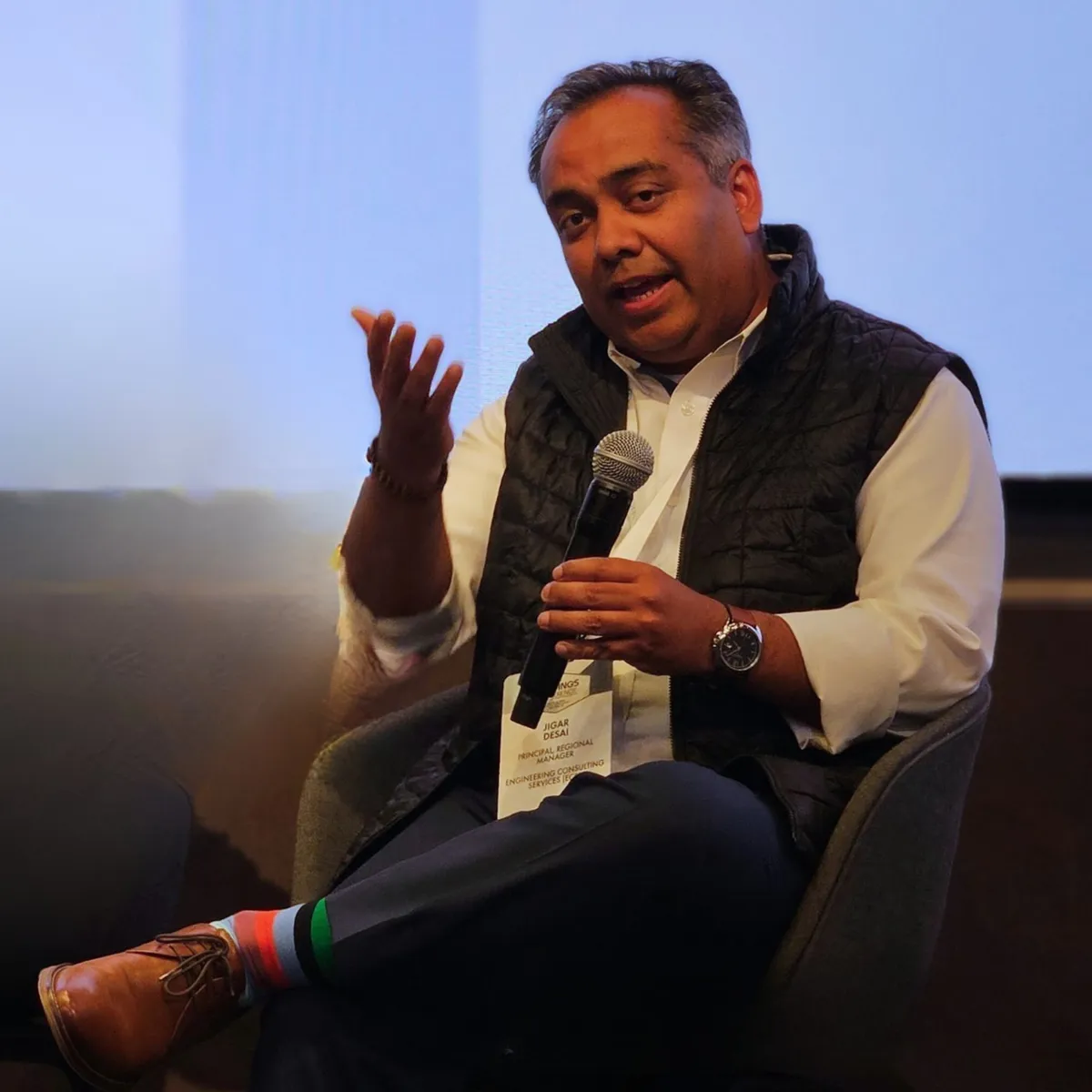 Jigar Desai seated with microphone at BuiltWorlds Buildings Conference in New York