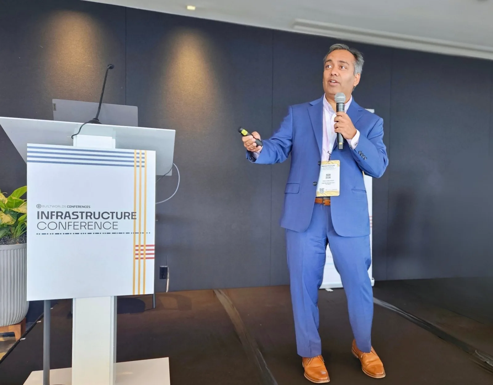 Jigar Desai speaking on stage at BuiltWorlds Infrastructure Conference - full body