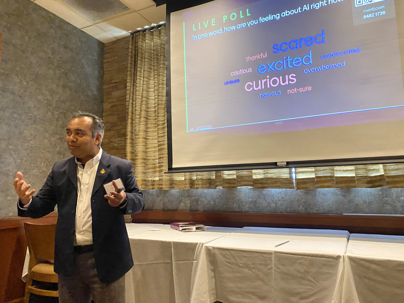 Jigar Desai speaking at CREW Greater Philadelphia during a live poll on AI sentiment